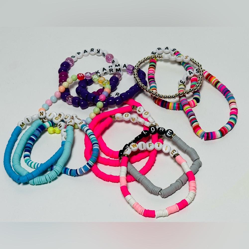 Set of 14 vibrant beaded bracelets with various colors and letter beads.